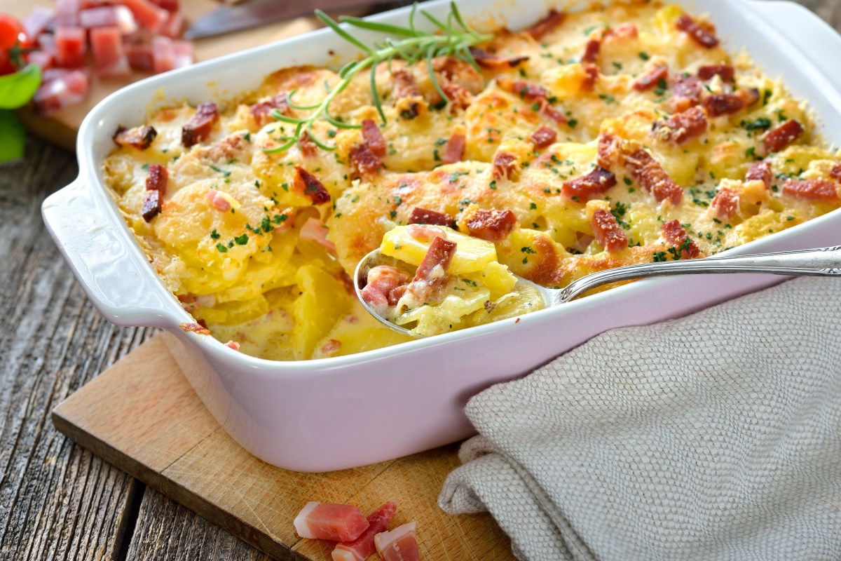 Carbonara potato casserole with bacon in a baking dish, close-up.
