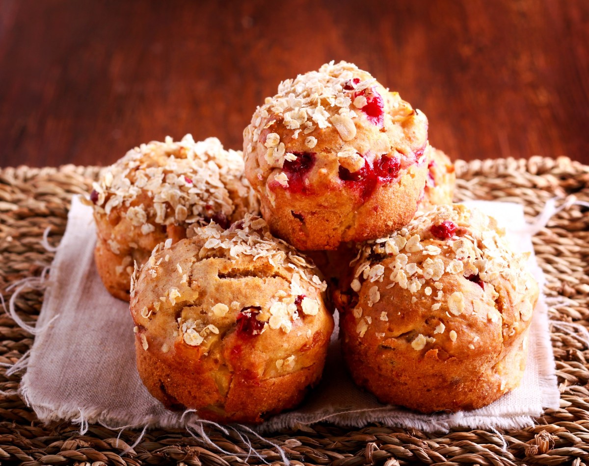 Several cranberry-oat muffins on a table