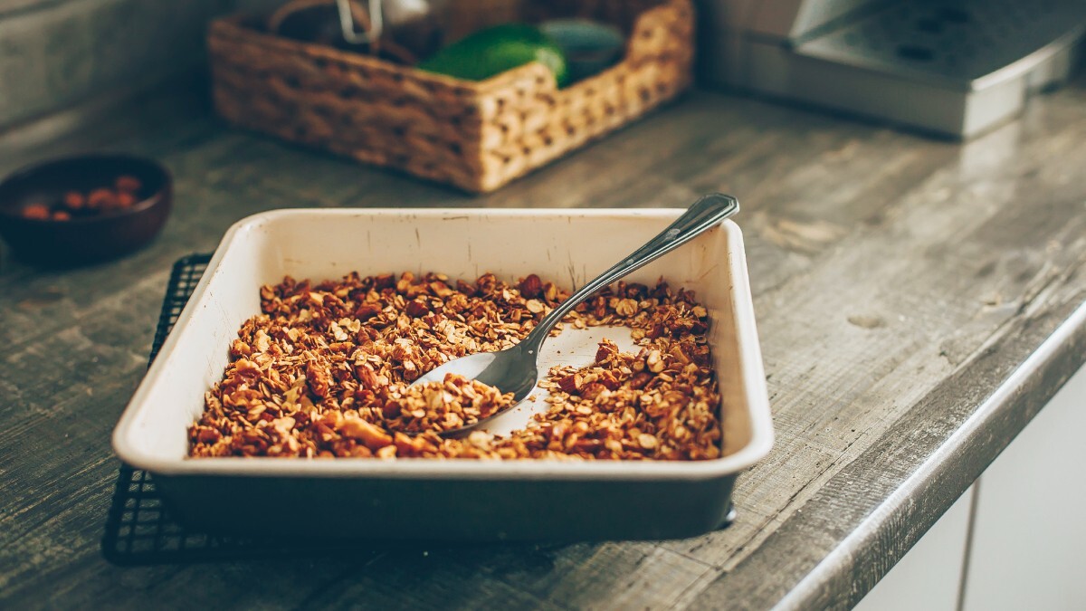 Roasted oats in a baking dish. It sits on a counter in the kitchen.