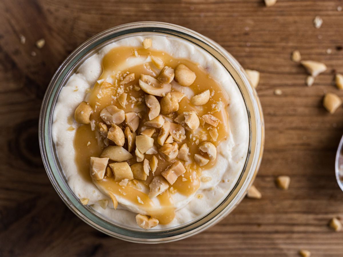 Snickers bowl served in a bowl, with peanut pieces scattered around it.