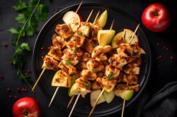 Apple-chicken skewers on a plate
