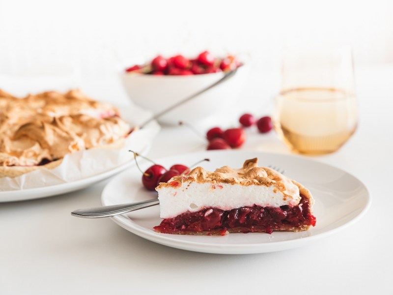 A piece of cherry cake with meringue.