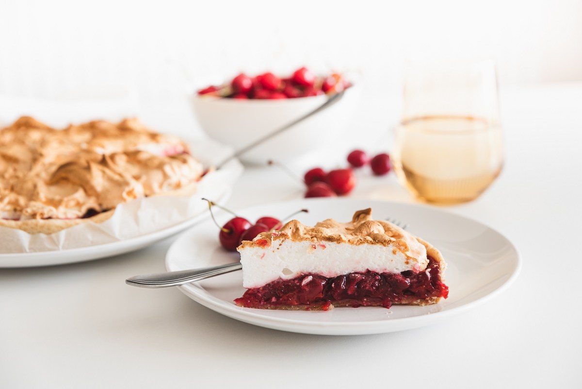 A piece of cherry cake with meringue.