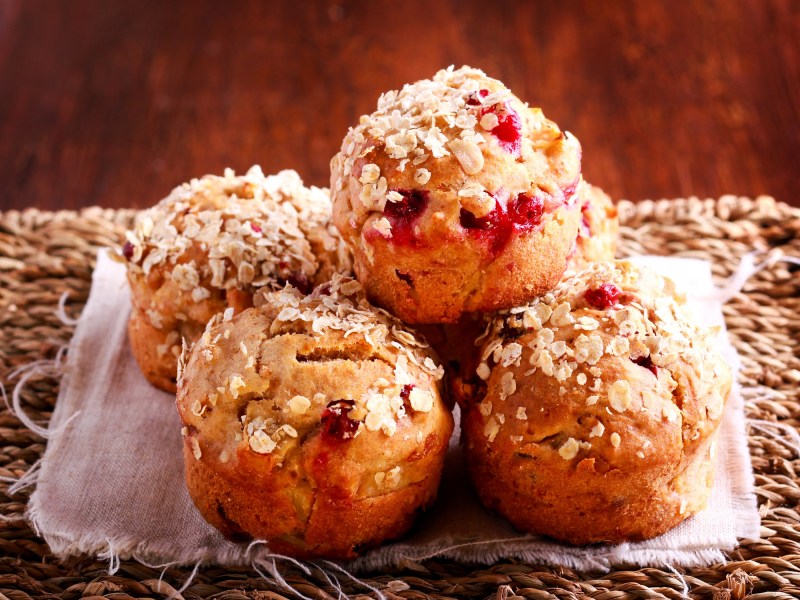 Several cranberry-oat muffins on a table