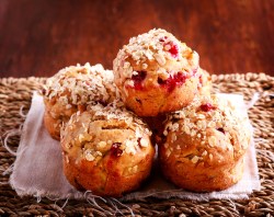 Several cranberry-oat muffins on a table
