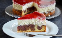 A piece of Little Red Riding Hood Cake on a plate. The rest of the cake is in the background.