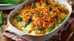 Chicken and rice casserole with asparagus in a baking dish with a cornflake crust.