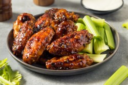 Honey Garlic Chicken with celery sticks on a plate.