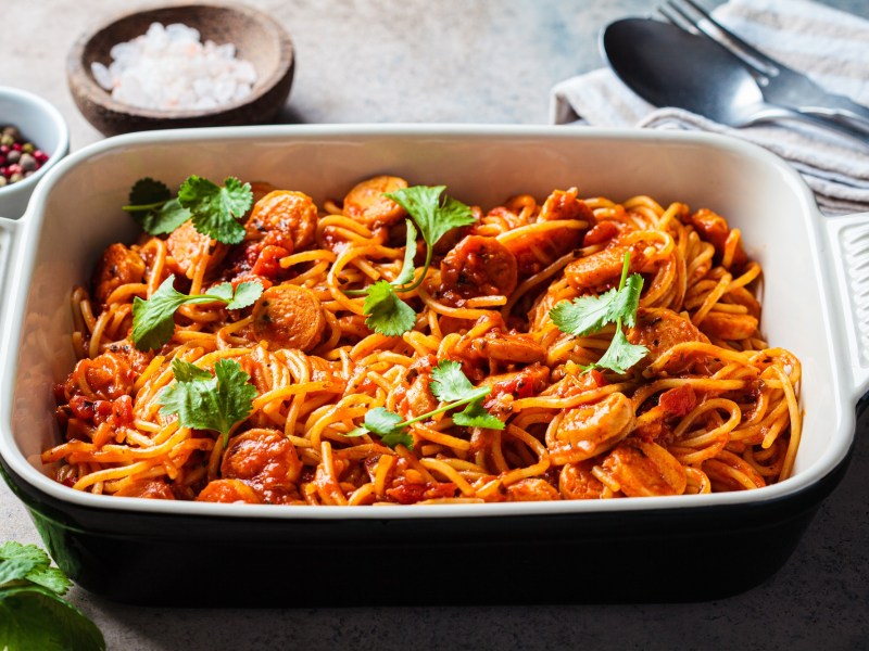 Oven-baked spaghetti with sausage in a baking dish.