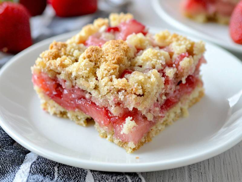 A piece of strawberry crumble cake on a plate