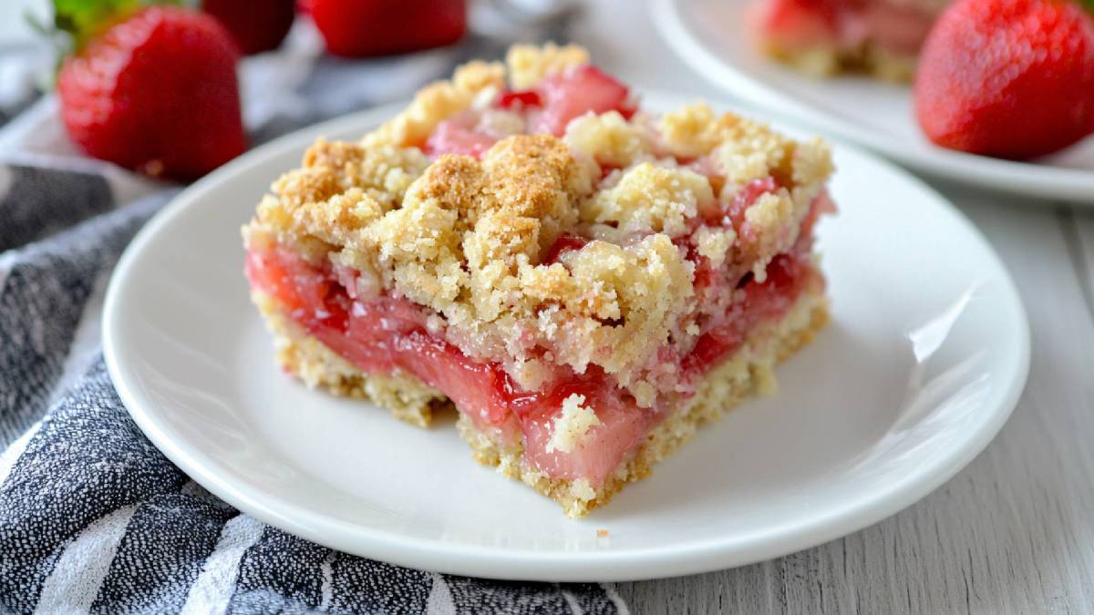 A piece of strawberry crumble cake on a plate