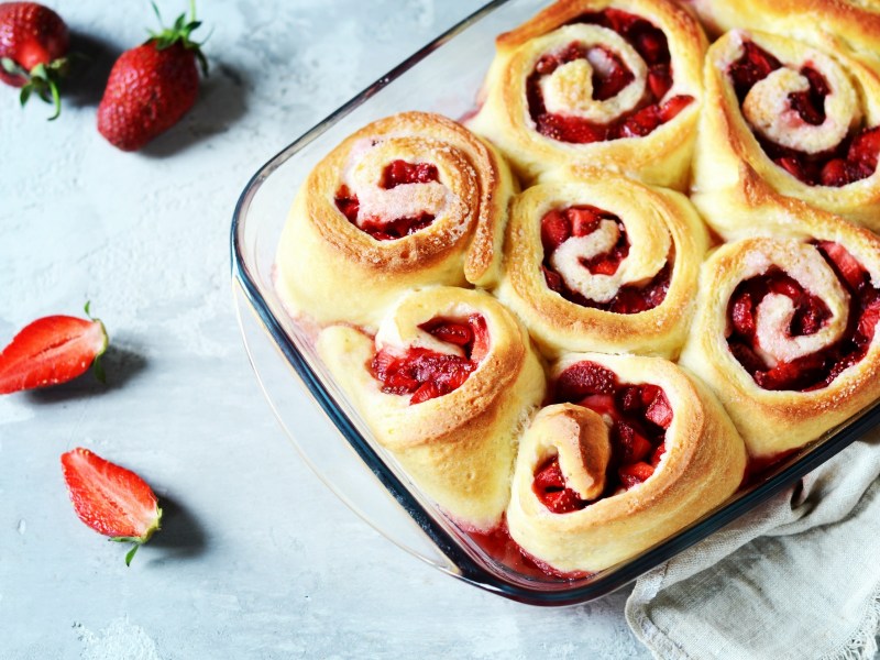 Baking dish with strawberry cinnamon rolls.