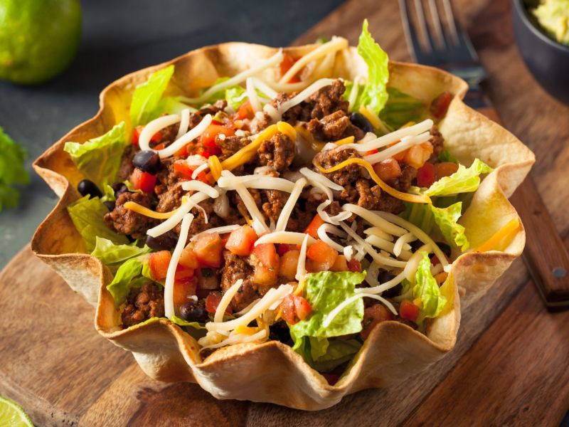 Taco salad served in a bowl of tortilla chips