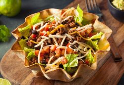 Taco salad served in a bowl of tortilla chips