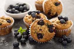 several blueberry muffins with vanilla pudding