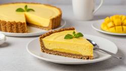 Sliced mango cream tart on a table