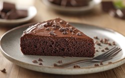 A piece of Nutella cake with chocolate shavings on a plate.