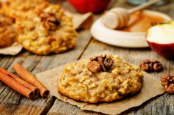 An oatmeal apple cookie on an autumnal table.